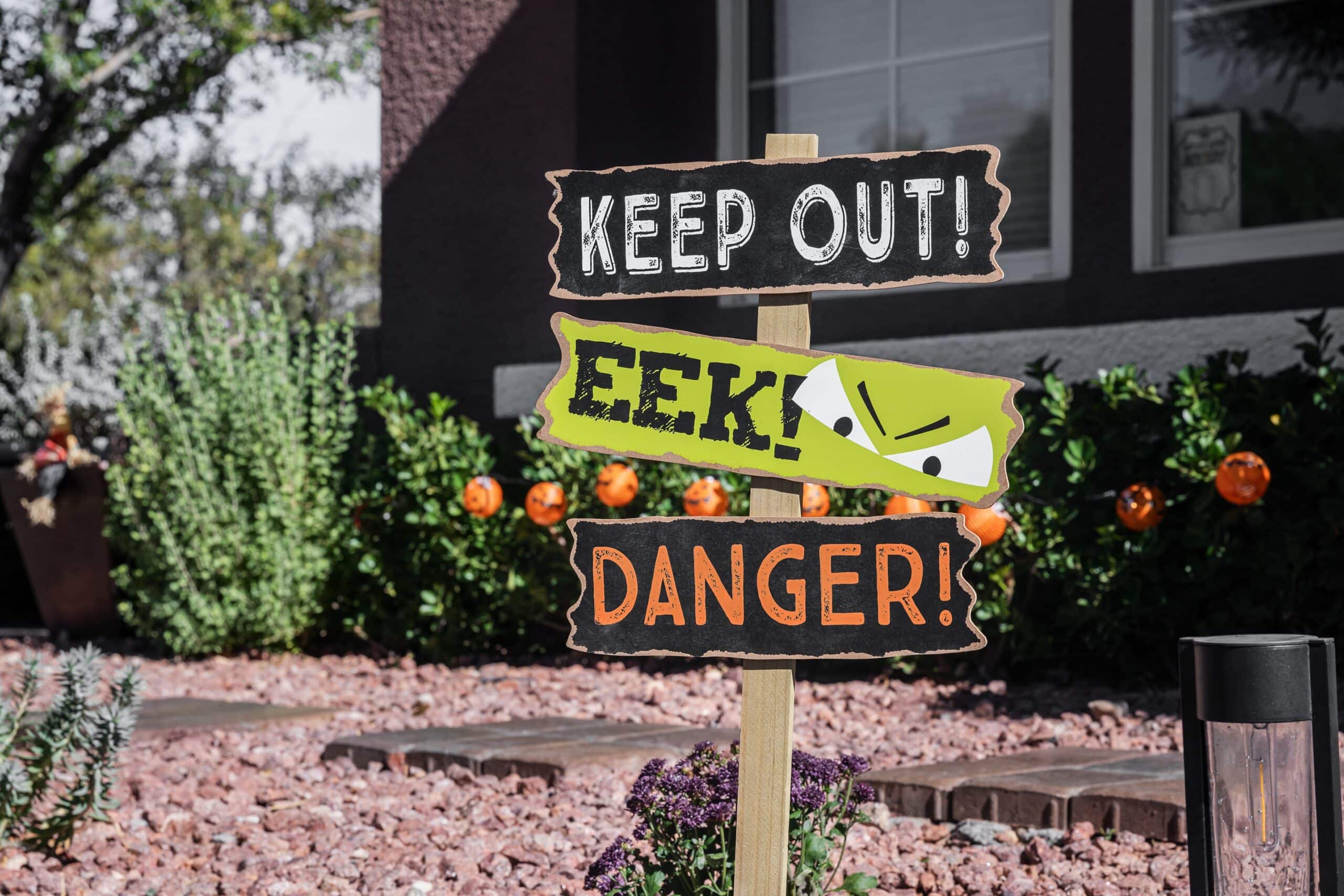 Halloween yard decorations with Keep Out and Danger warning signs