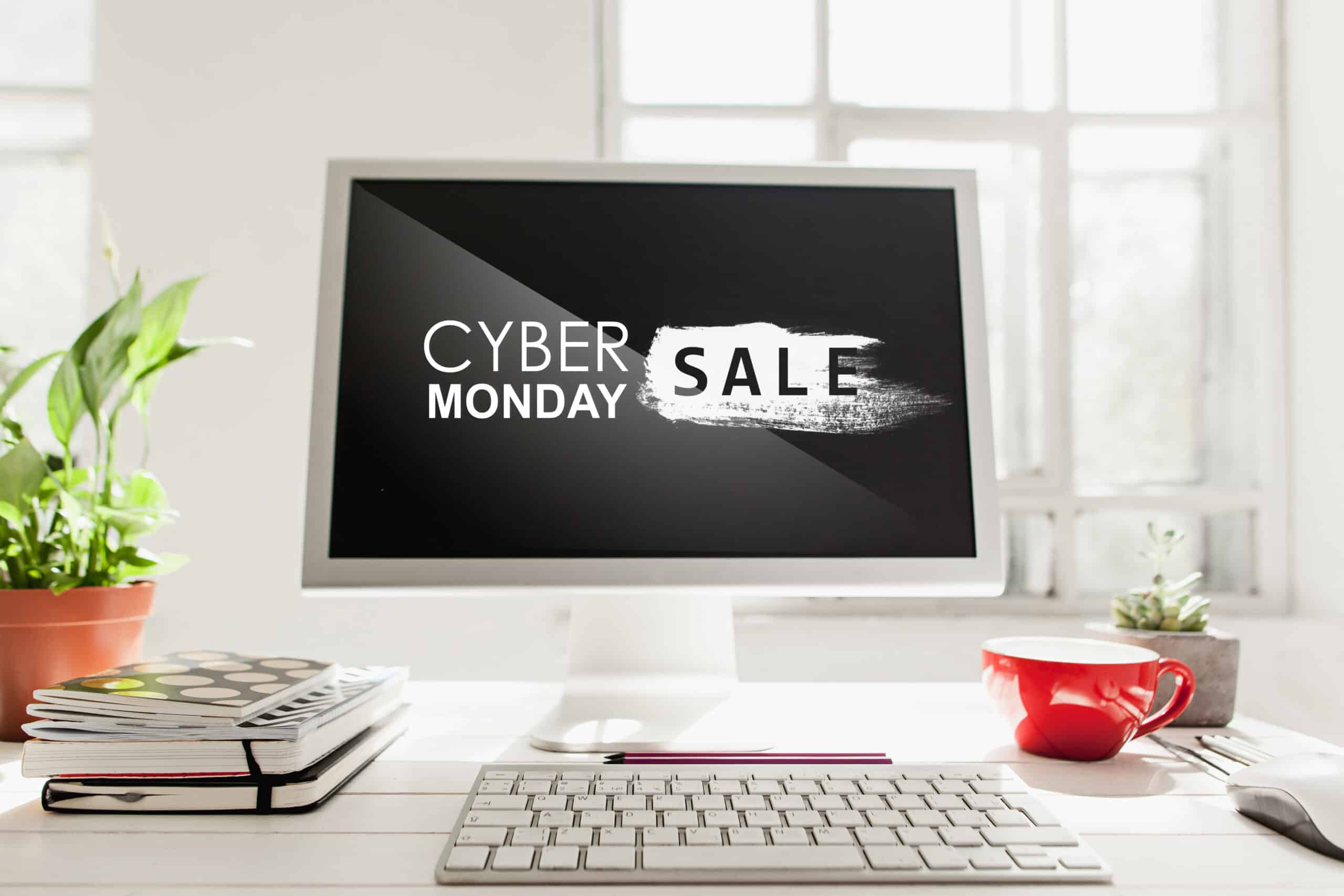 Desktop computer displaying a Cyber Monday Sale message on a desk