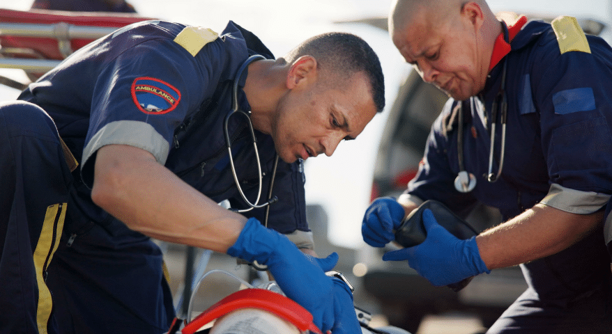 Paramedics treating a patient at the scene of an emergency