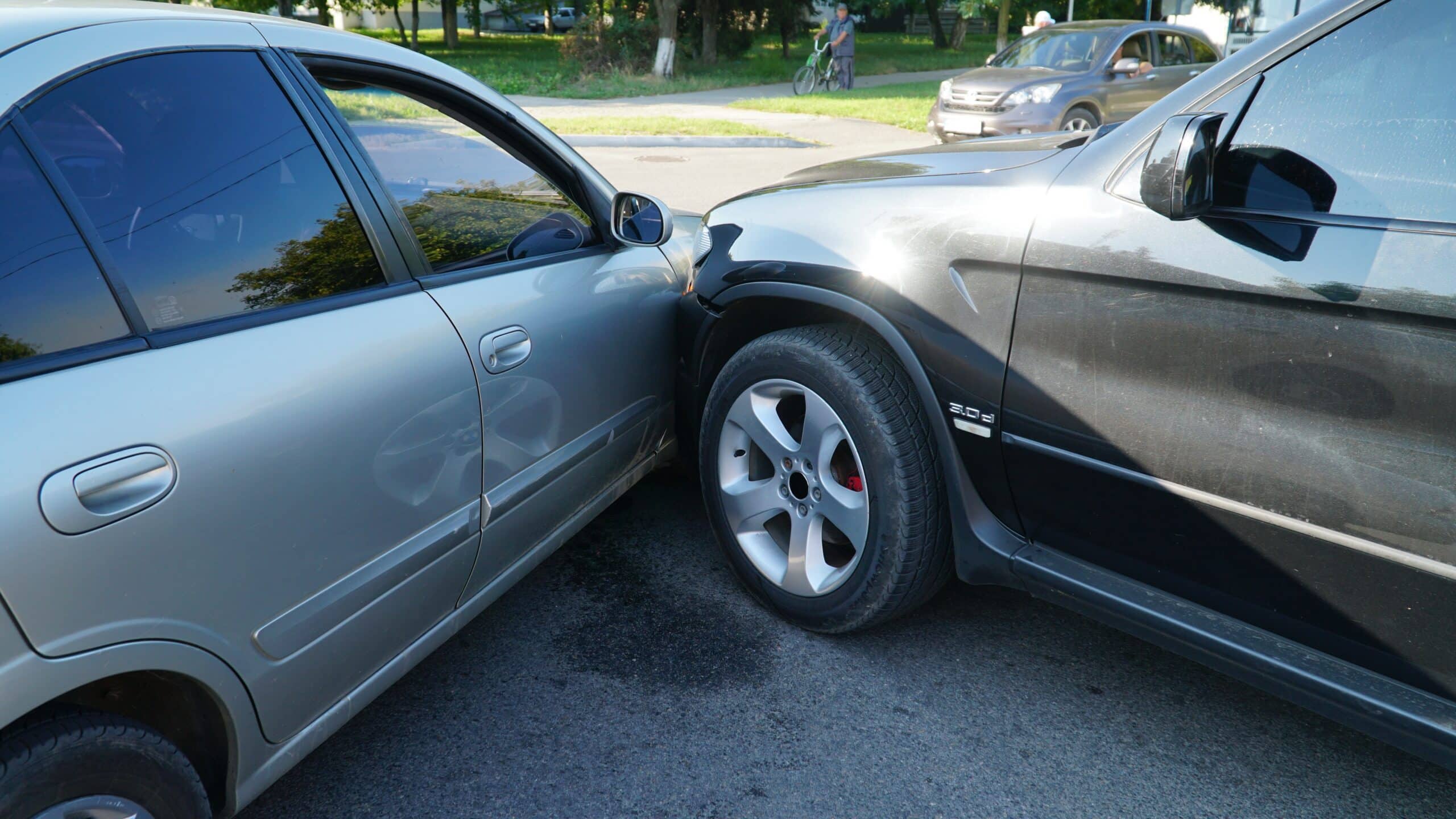 Silver car with front-end damage after an intersection collision