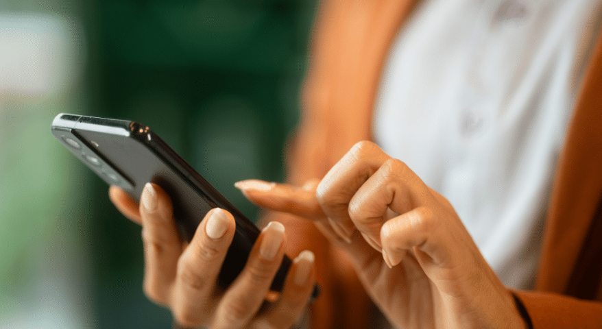 Person tapping on a smartphone screen held in both hands