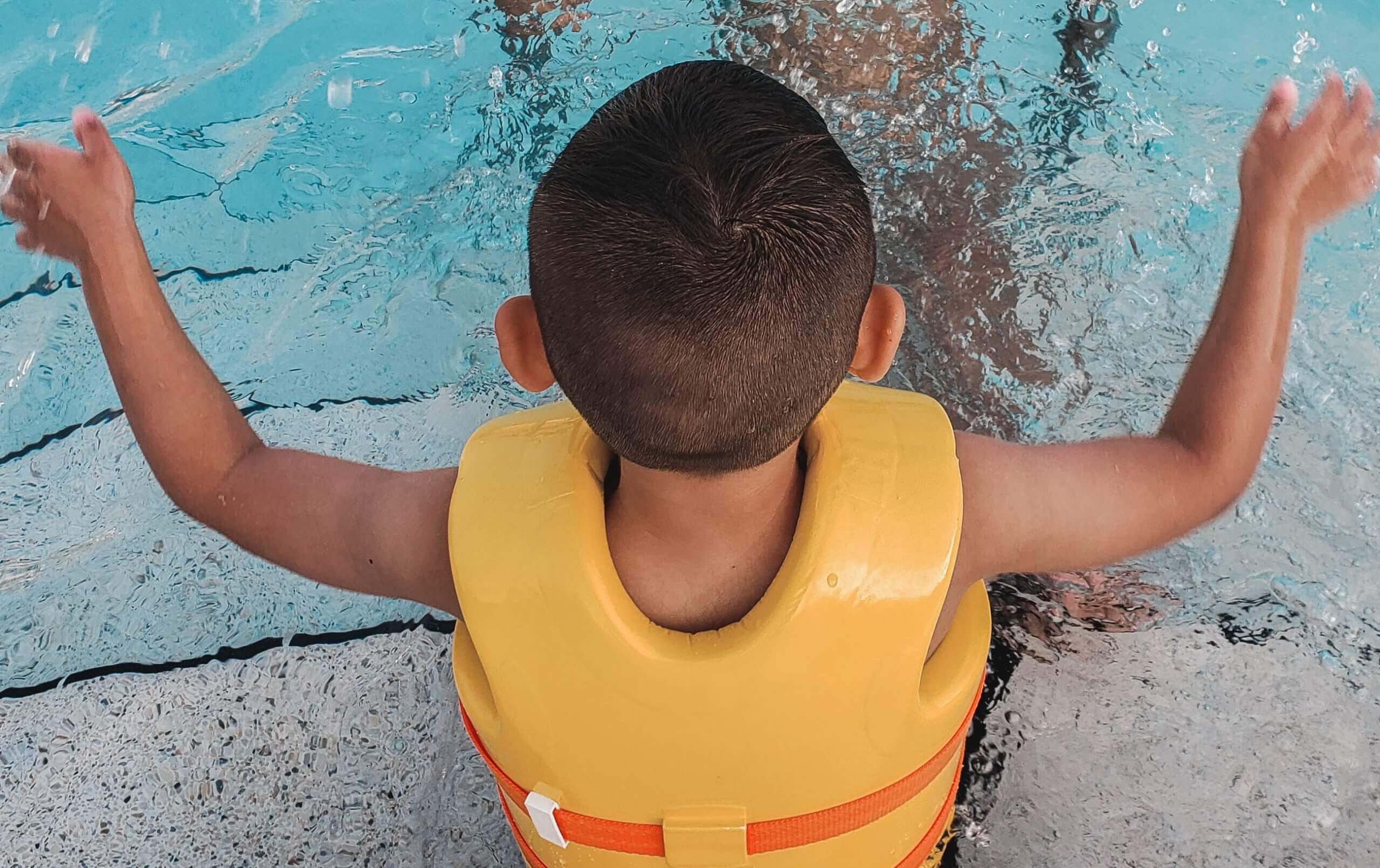 Child practicing swim safety