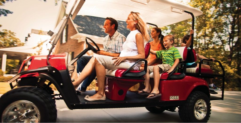 Family riding in a golf cart