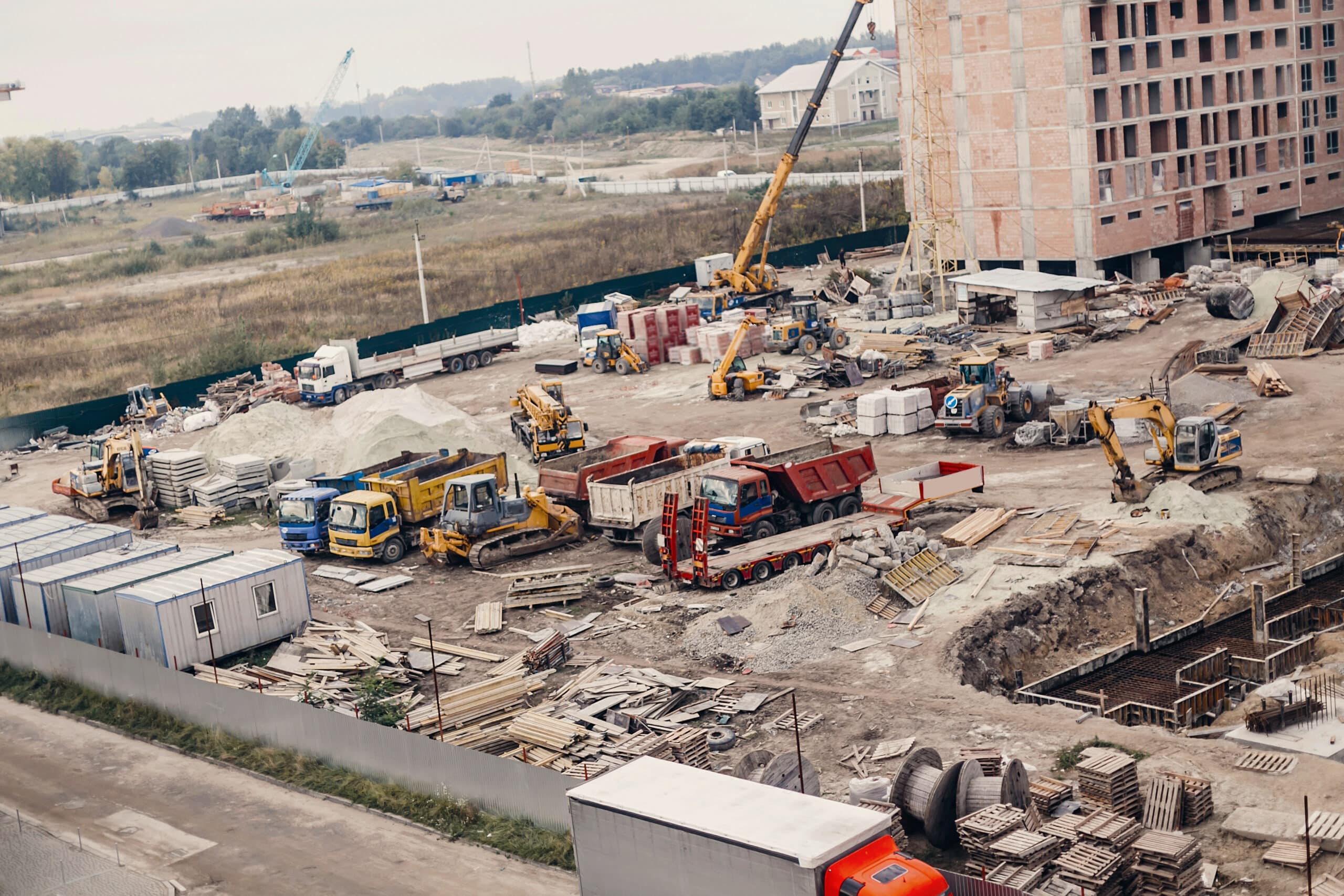 Active construction site with cranes and heavy equipment