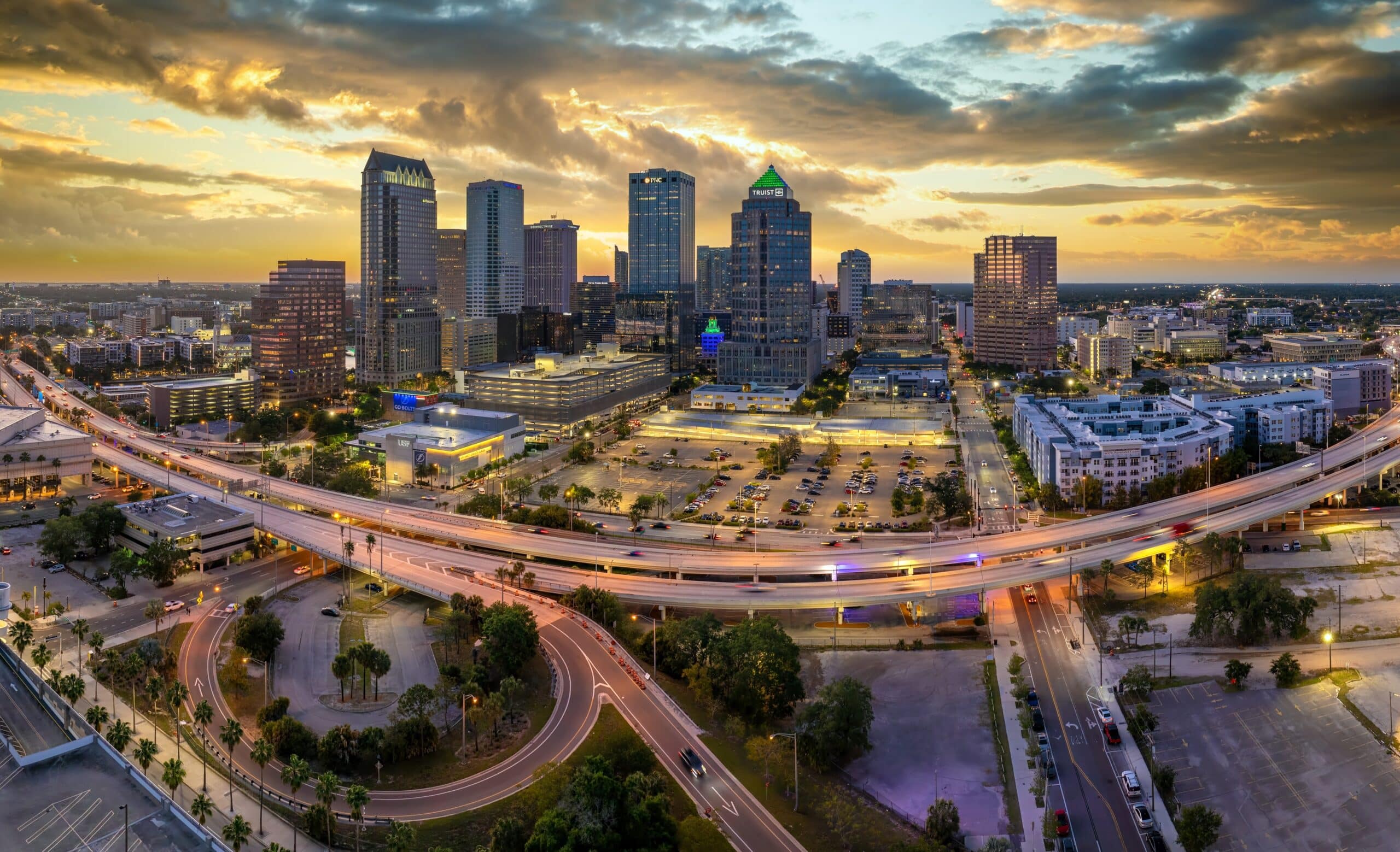 Aerial view of the Tampa skyline and highway interchange at dusk