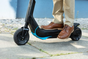 man riding an e scooter