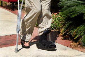 injured person walking on crutches