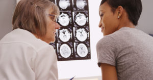 woman talking to a doctor about her head injury