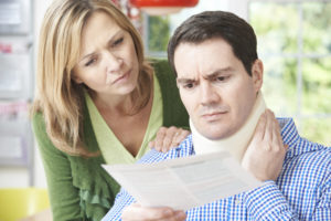 injured man and wife read over medical paperwork