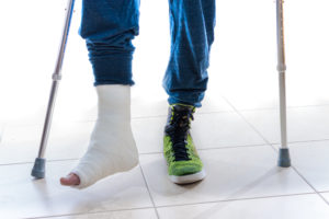 injured person using crutches
