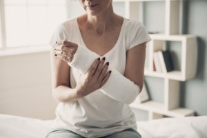 injured woman holding her broken arm