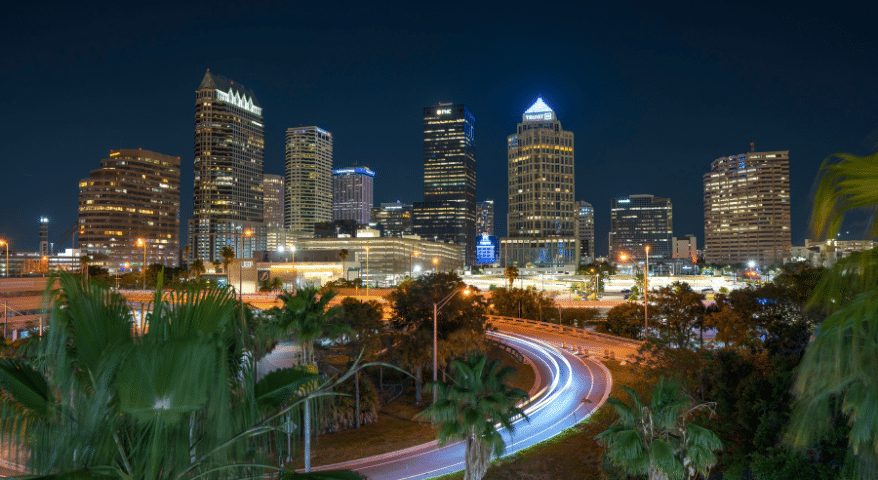 Tampa city skyline glowing at night with streaks of traffic light
