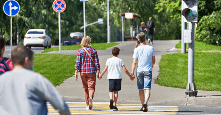 Boy holding hands with parents