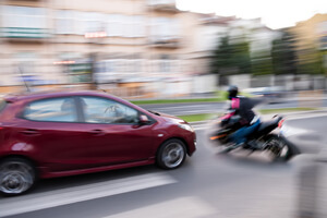 A car and motorcycle are about to crash, it is unclear who is at fault.