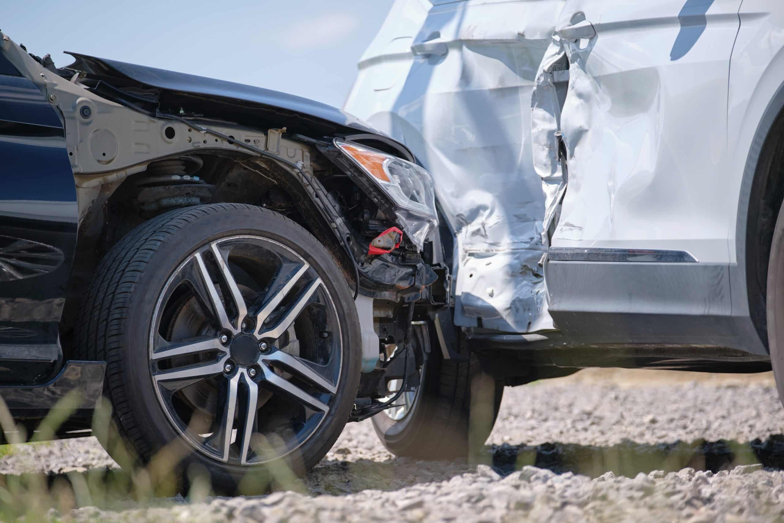 Close-up of a car with a crumpled, damaged side panel after a collision