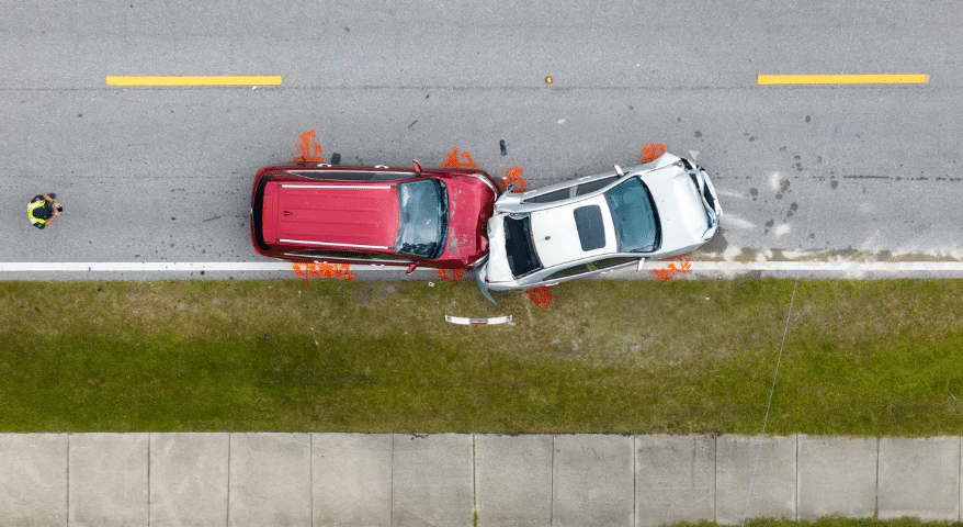 Aerial view of two cars after a collision on the roadside