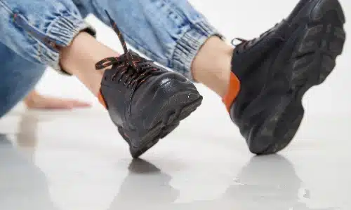  A closeup of a girl's lower legs as she props herself up after a fall.