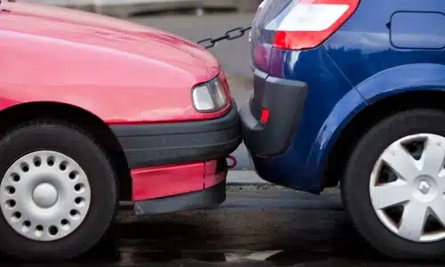 A minor rear-end collision between a red car and a blue hatchback.