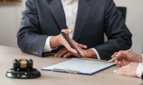 A personal injury lawyer explaining a client's insurance policy to them in order to maximize a claim.