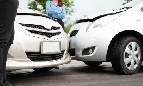 Two drivers conversing with each other after their vehicles collided with each other.