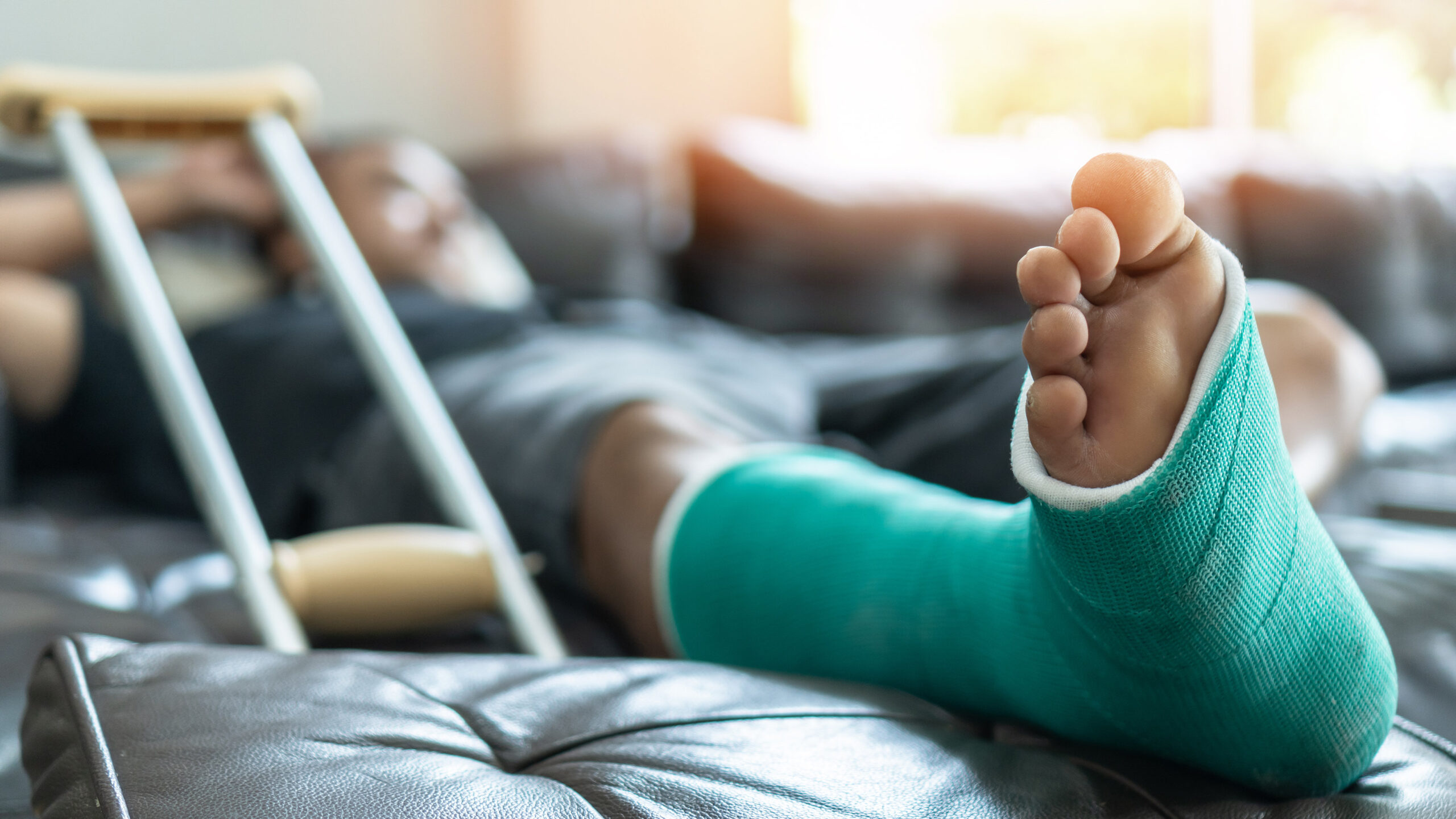 man resting at home with foot injury