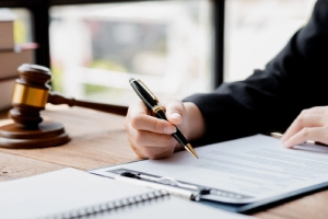 A Land O' Lakes personal injury lawyer at a desk writing in his notebook while working on a claim.