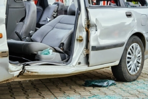 A side shot of a grey SUV missing its door after a T-bone car accident.