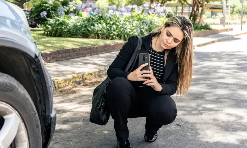 Tampa Lyft accident lawyer documents vehicle damage by photographing another car involved in her client’s accident case.