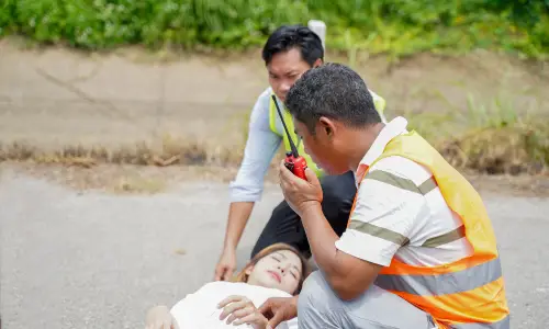 Two emergency responders assist an unconscious woman after a hit-and-run accident in Tampa.