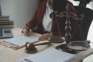A hit nad run lawyer accident lawyer serving Carrollwood in a red blazer is sitting and working inside her law office
