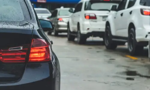 Car tail lights glow amid rush-hour traffic congestion, creating conditions prone to rear-end collisions.