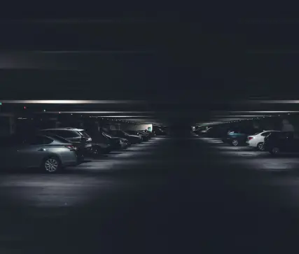 Dark dimly lit parking garage representing unsafe property conditions in a Tampa premises liability case