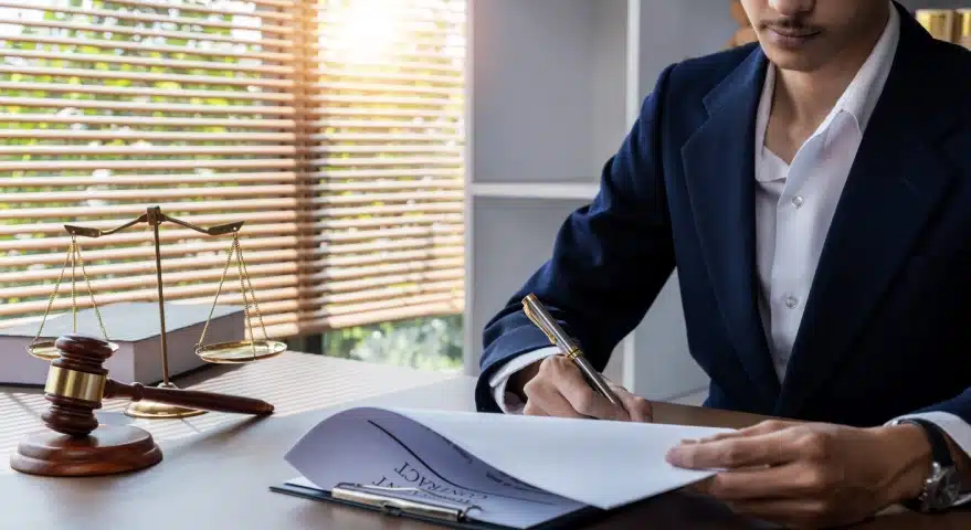 A Florida slip and fall lawyer sitting in a law office and signing legal documents