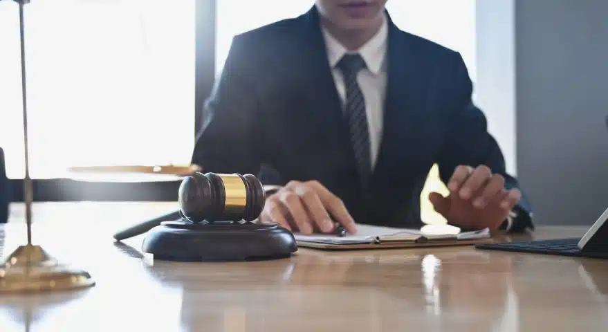 A Florida slip and fall lawyer writing on an open notebook while he sits in a law office