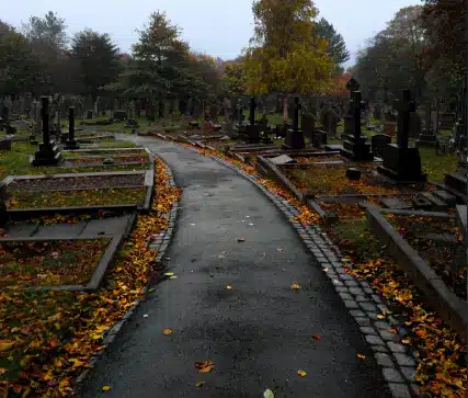 Rainy cemetery path with headstones representing a wrongful death claim in Tampa Florida