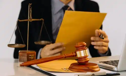 A Riverview birth injury lawyer in his office opening an envelope containing documents for a client's claim.