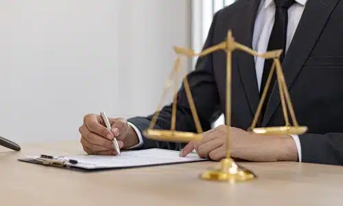A Riverview boating accident lawyer filling out a clipboard holding forms for a client's personal injury claim.