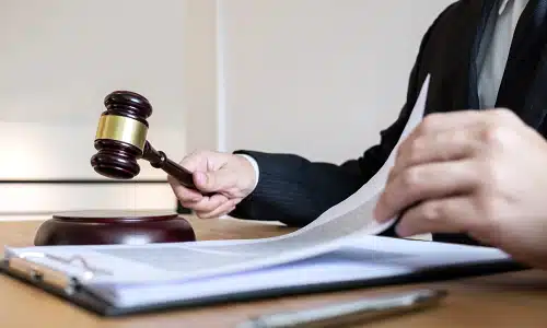 A Riverview car accident lawyer is reading through legal documents attached to a clipboard