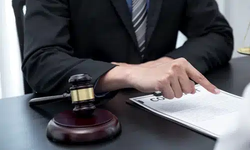A Riverview electrocution accident lawyer pointing at a specific line in a client's insurance contract.