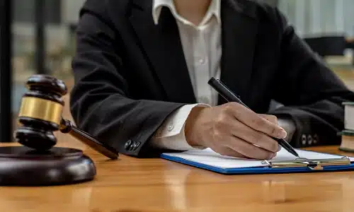 A Riverview product liability lawyer seated at his desk and reviewing a client's personal injury claim on a clipboard.