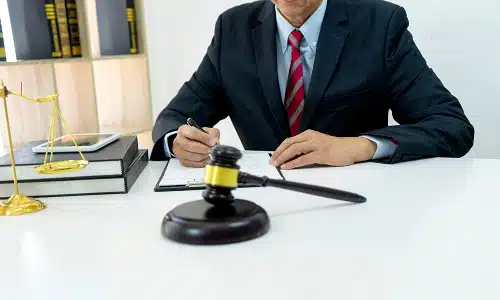 A Riverview truck accident lawyer sits in a law office while signing legal documents