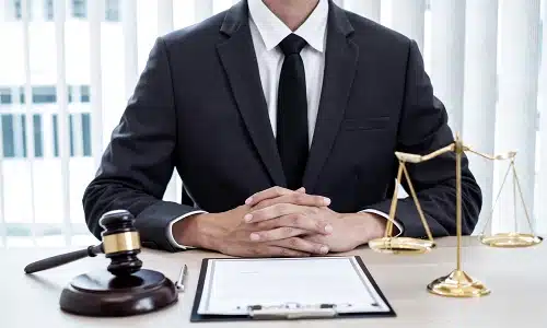A Riverview wrongful death lawyer at his desk with a clipboard in front of him holding a client's personal injury policy.