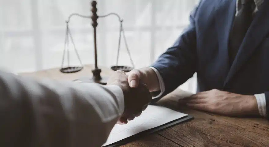 A Tampa storm clean up injury lawyer shakes hands with a satisfied client