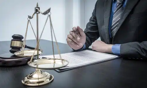A Tampa bicycle accident lawyer reviewing a legal document attached to a clipboard on an office desk