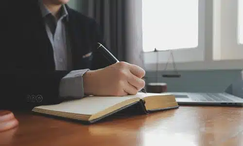 A Tampa boating accident lawyer writting down notes on a notebook