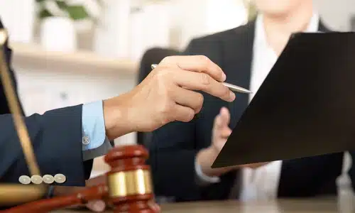 A Tampa brain injury lawyer showing a document to a colleague while pointing at it with a pen