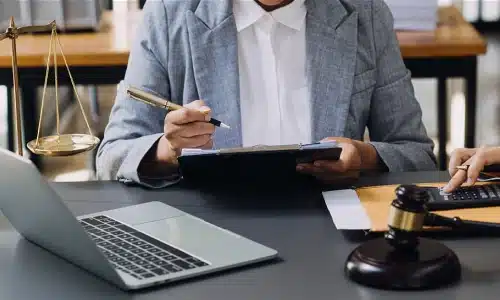 A Tampa catastrophic injury lawyer holding a clipboard at a desk and preparing for a claim.