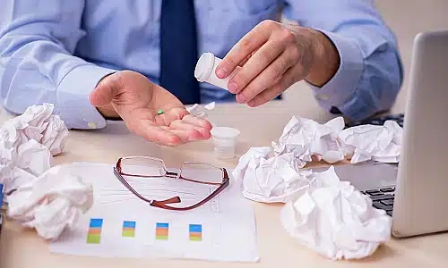 A photo of a physician assessing a medicine for potential defects.