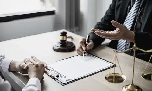 A Tampa wrongful death lawyer going over the details of a contract with a client sitting on the opposite side of a table